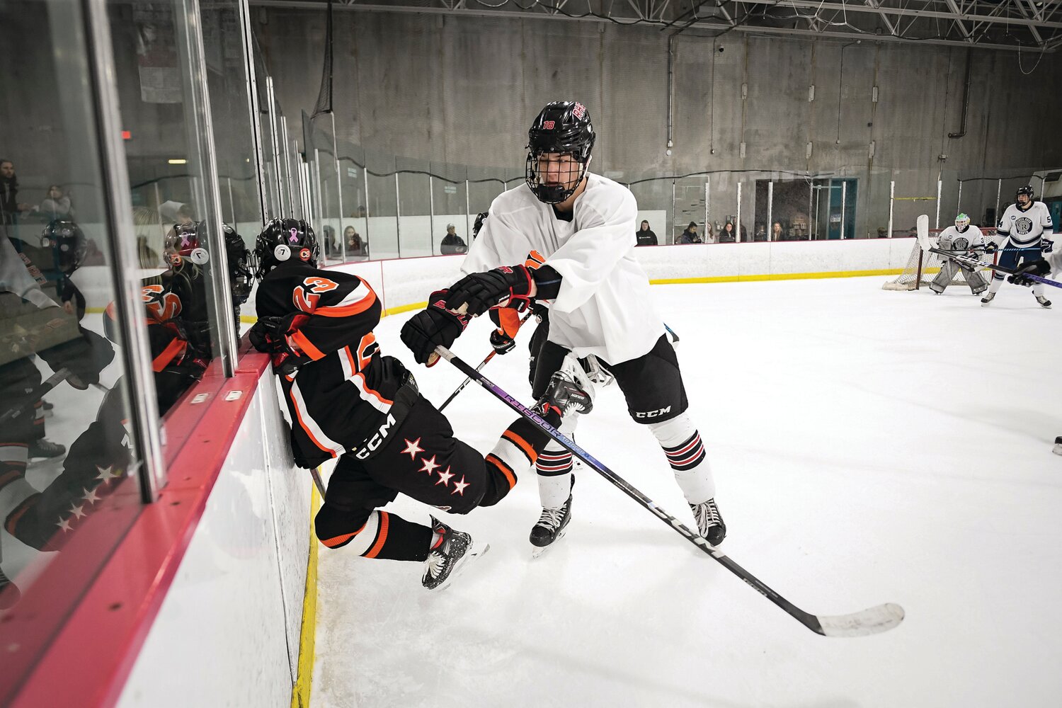 Council Rock North’s Jackson Accardi sends Pennsbury’s Jake Seiler into the boards with a heavy check in the first period.
