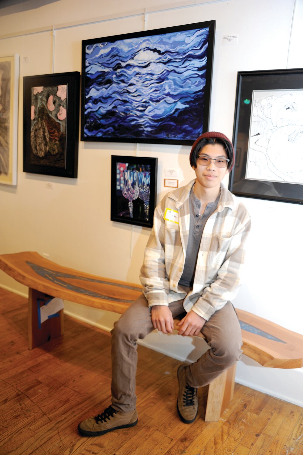 Jack Weber sits on his piece“Splitting River,” which won first place in the 3-Dimensional Works category.