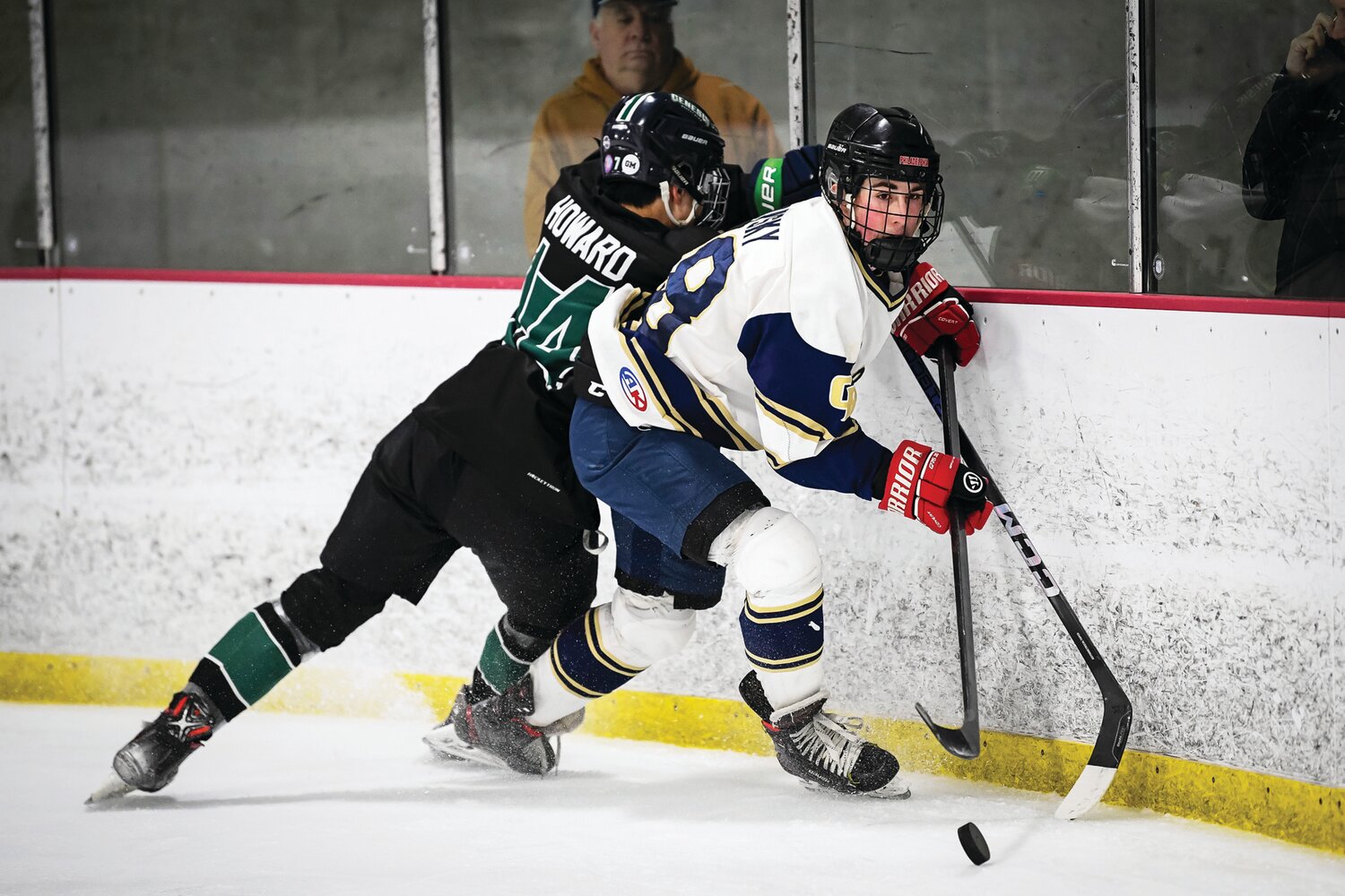Council Rock South’s Chase Tovsky works the puck out of the corner despite a backcheck from Pennridge’s Dhilan Howard.