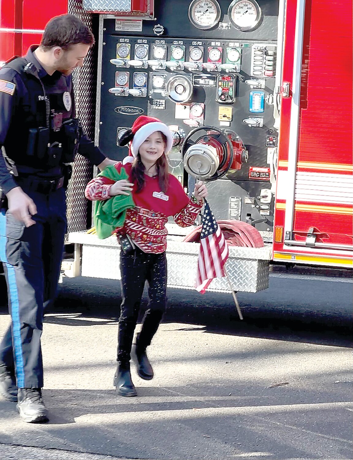 Layla Leuthy Peck is escorted off the firetruck by her father, Sean Peck, Pendel Police officer.
