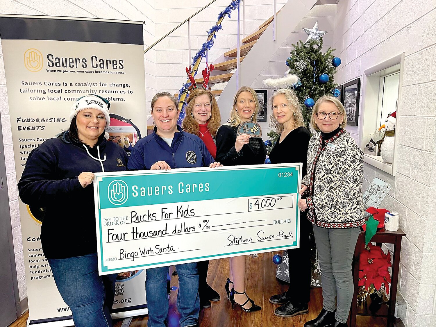 From left, Stephanie Sauers Boyd and Danielle Fox, both of Sauers Cares, stand with Bucks for Kids’ Nancy Larkin Taylor, Dawn Padanyi, Lodina Slawecki and Linda DeMario.