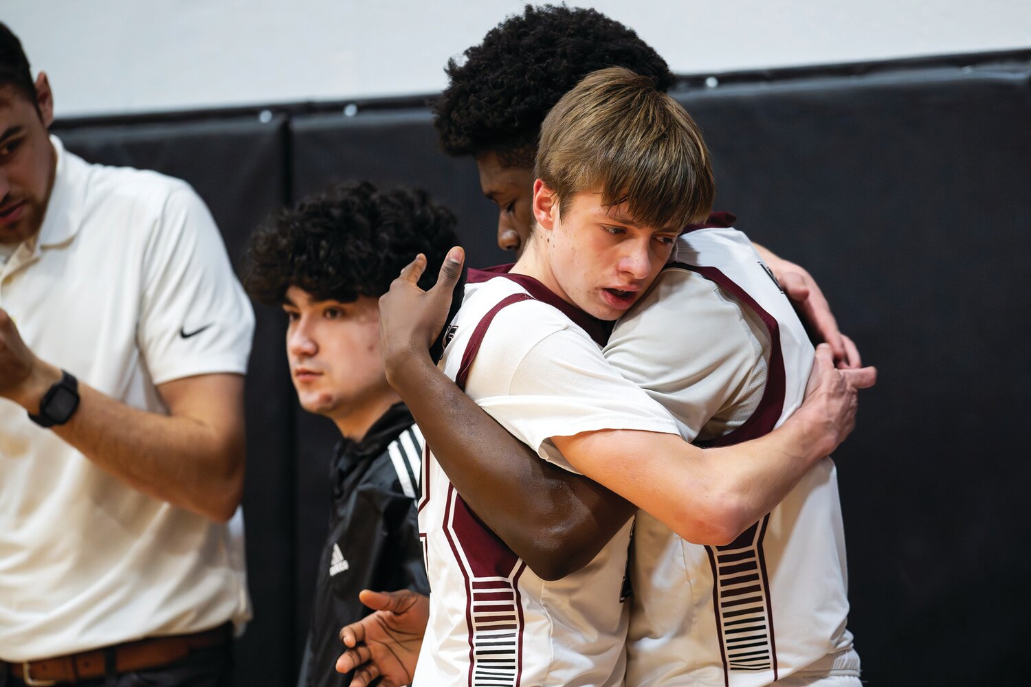 Faith Christian Academy’s Paul Leisner gets a hug from teammate Matt Calixte after being taken out for the last time late in the fourth quarter.