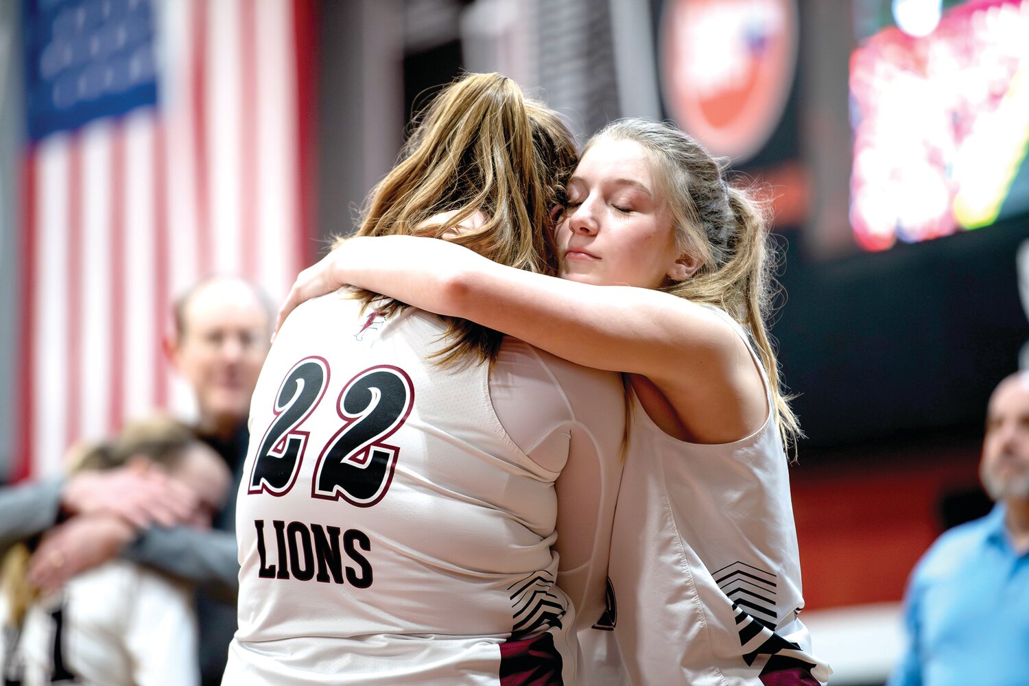 Faith Christian’s Kendal Robison gets a hug from teammate Kylie Personett after a 38-35 playoff loss.