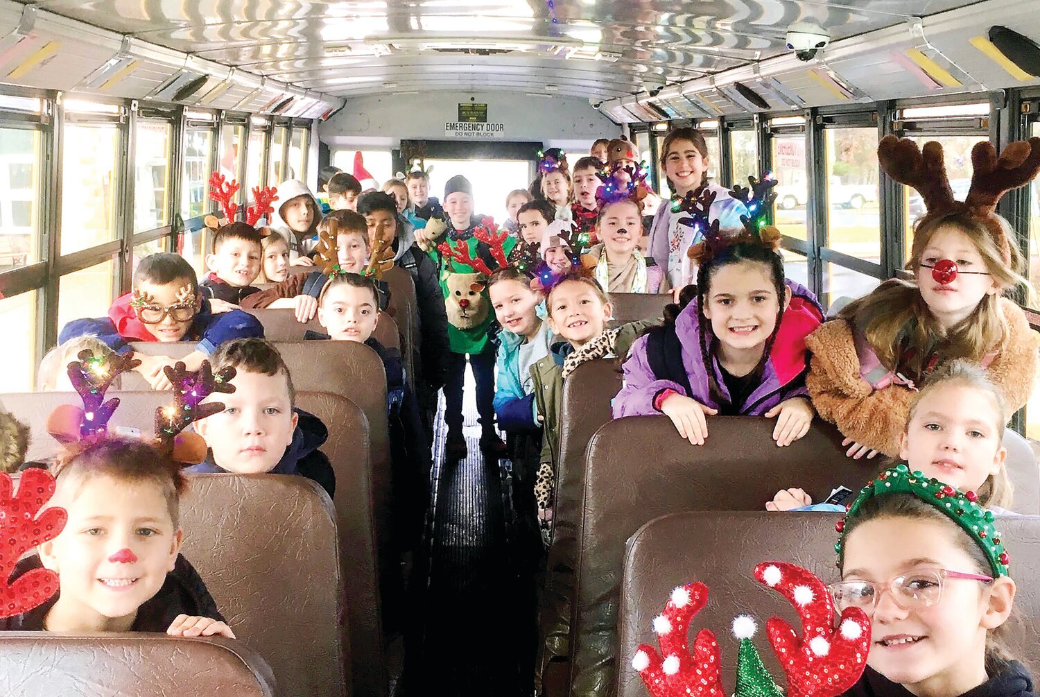 Children aboard the bus are dressed for the holidays.