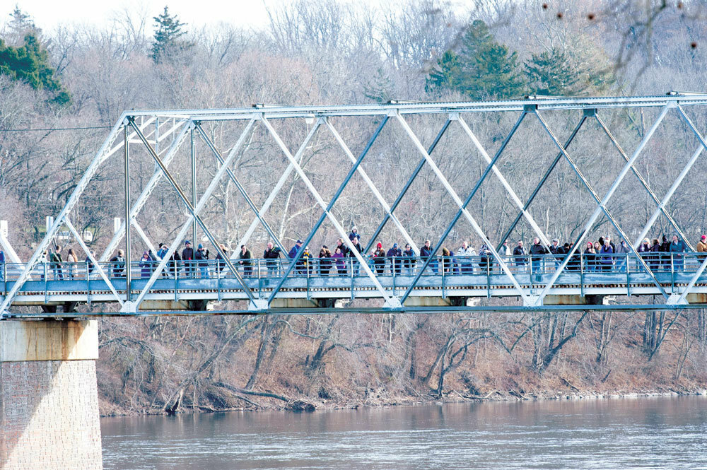 Spectators line the Washington Crossing Toll-Supported Bridge on Christmas Day 2019 to watch the annual Delaware River crossing reenactment. The Delaware River Joint Toll Bridge Commission is floating a plan to replace the span.