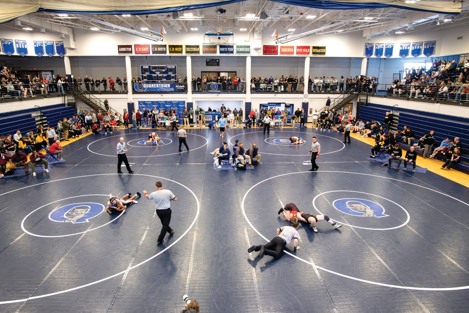 The first year of PIAA girls wrestling at a packed Quakertown Community High School gym.