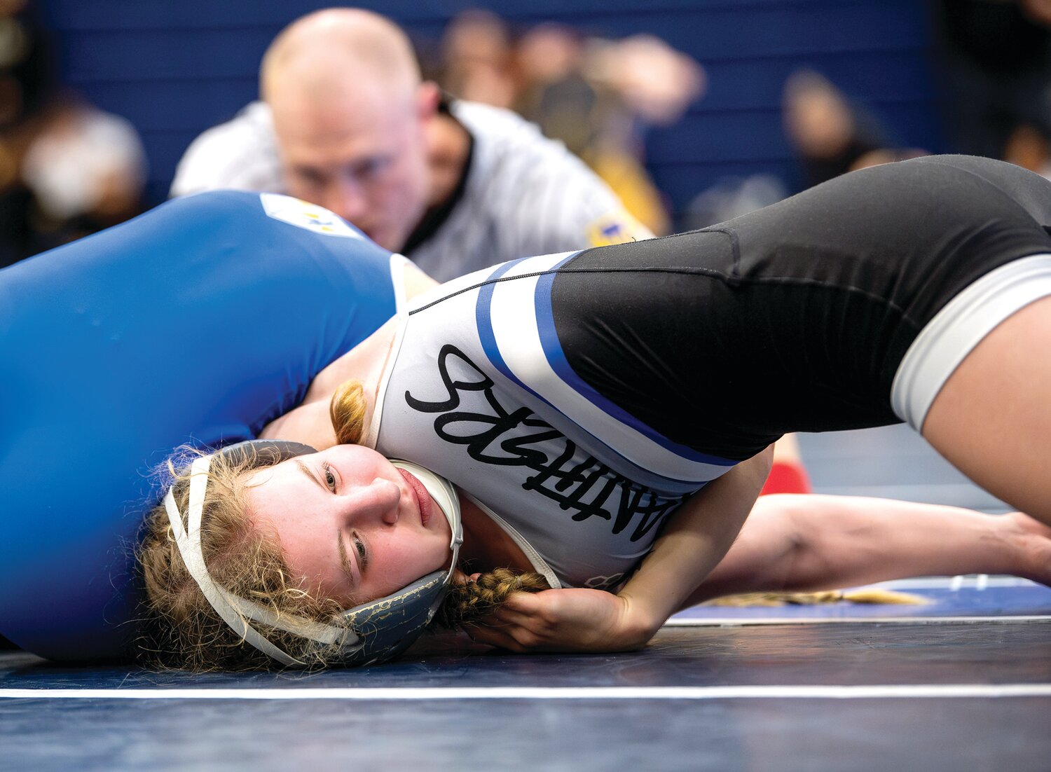Quakertown’s Ashley Stank gets twisted by Conwell-Egan’s Julia Horger during her 106-pound match.