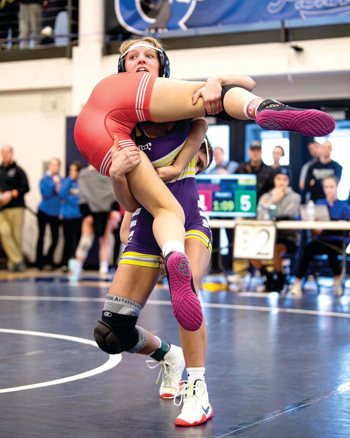 Palisades’ Savannah Witt lifts and drops an Owen J. Roberts wrestler during a 118-pound match.