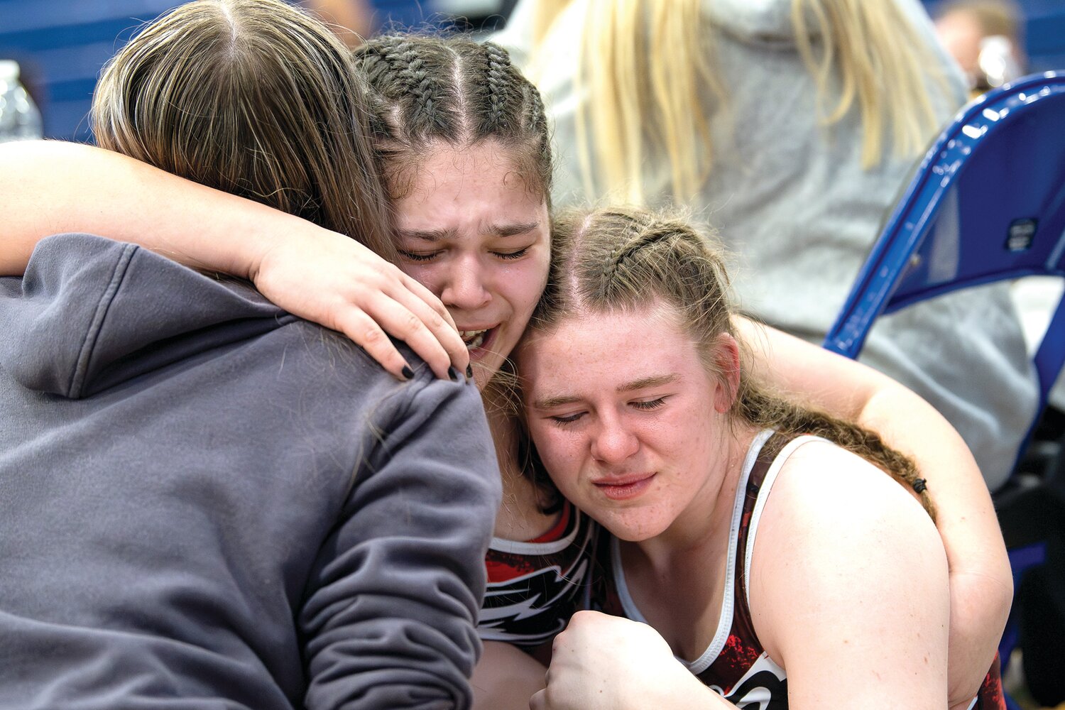 Alyssa Crespo, center, of William Tennent,  gets hugs from teammates Teagan Noll and Megan Gottschall after her fifth-place finish in the 190-pound weight class.