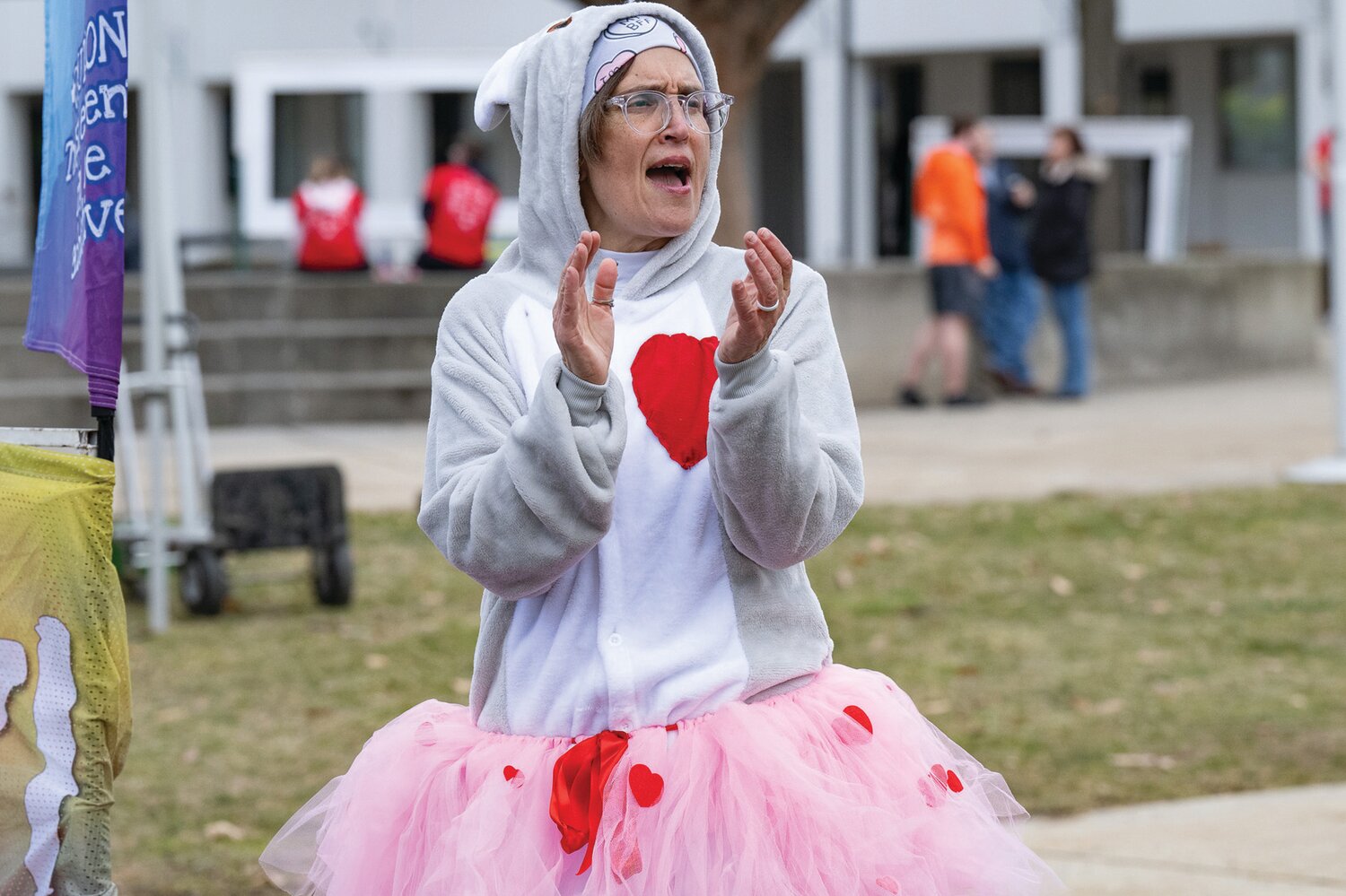 Jamie Bubeck, of King of Prussia, cheers on the many walkers and runners making their way to the finish line during the Great Cupid Run, an event hosted by Scoogie Events.