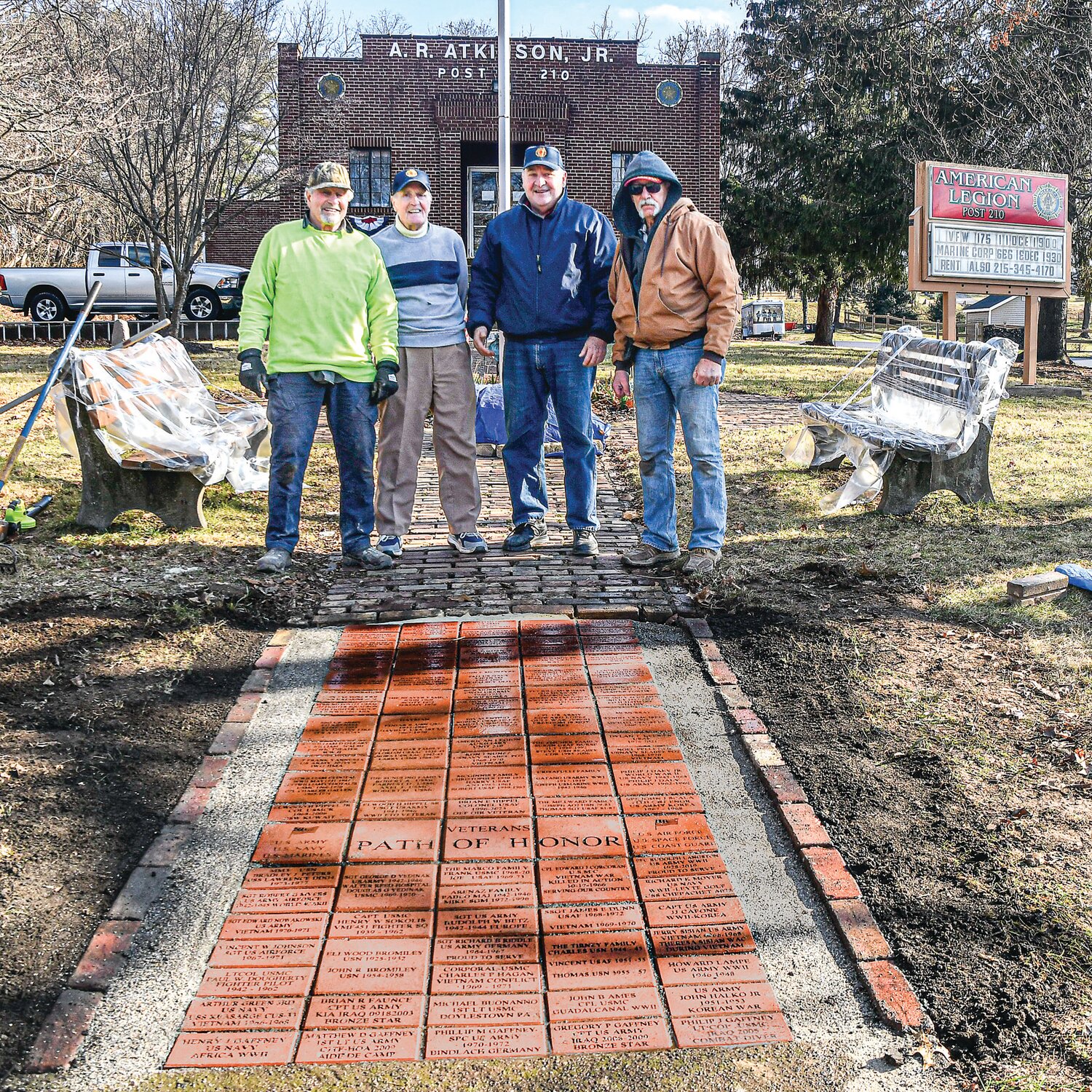 From left are Noel Pelletier, Tom Tirney, Tom Darringo and Bob Sundling, standing at the edge of the first section of the Path of Honor at Doylestown American Legion Post 210. The path honors and remembers past and present veterans and service members.