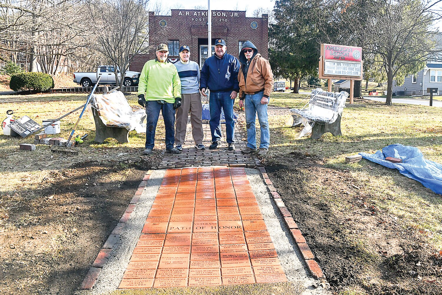 From left are Noel Pelletier, Tom Tirney, Tom Darringo and Bob Sundling, standing at the edge of the first section of the Path of Honor at Doylestown American Legion Post 210. The path honors and remembers past and present veterans and service members.
