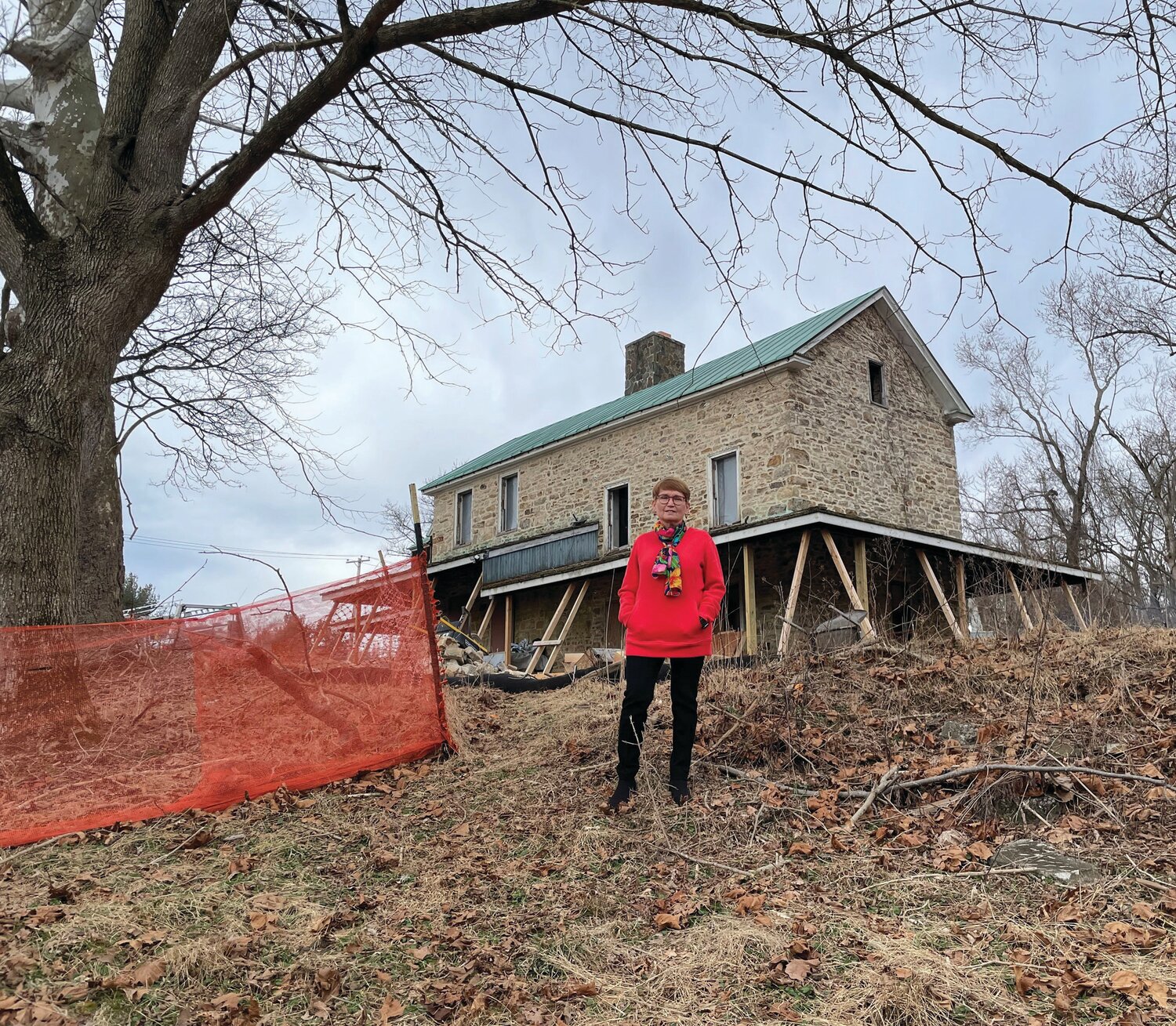 Patricia Mervine stands in front of the Godfrey Kirk house as reconstruction for the African American Museum of Bucks County is underway.