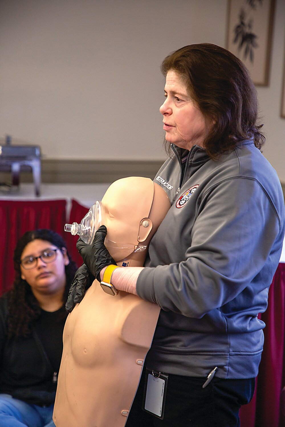 Instructor Gail Keagy leads a CPR training session for students at Middle Bucks Institute of Technology.