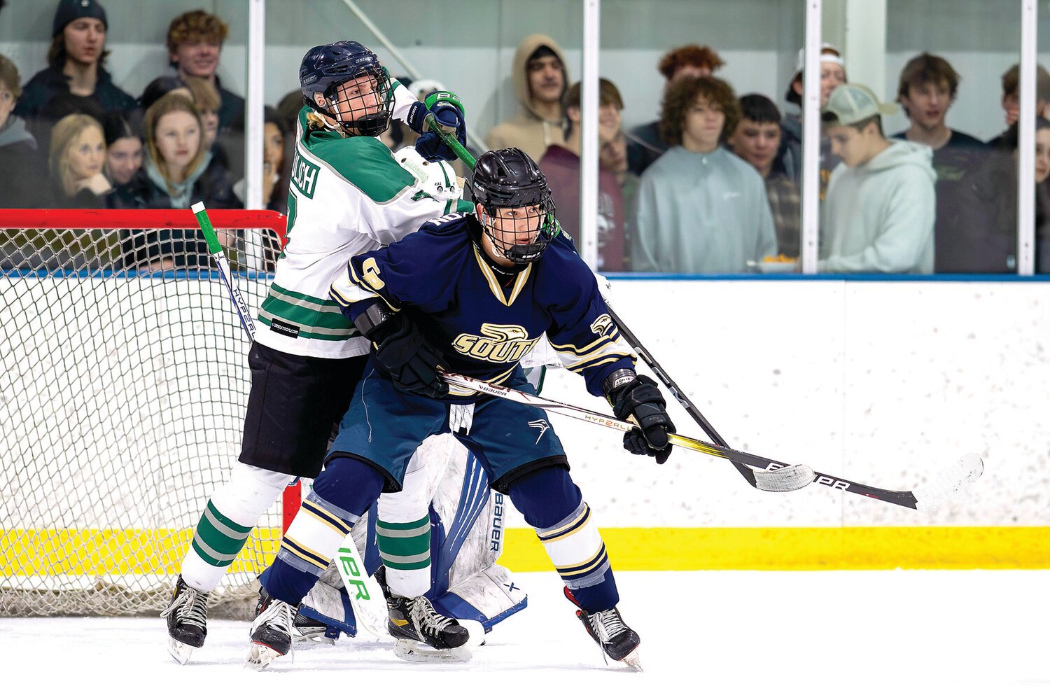 Pennridge’s John Mikulich tries to clear the front of the goal as Council Rock South’s Gavin Nisenzon puts on the pressure during the Suburban High School Hockey League final last Thursday.