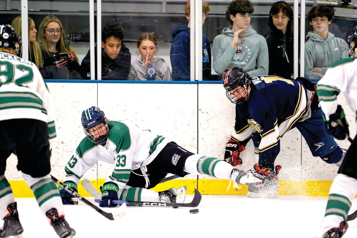 Pennridge’s Josh Kelly gets taken down in the corner by Council Rock South’s Jake Weiner as he tries to make a pass during the Suburban High School Hockey League final.