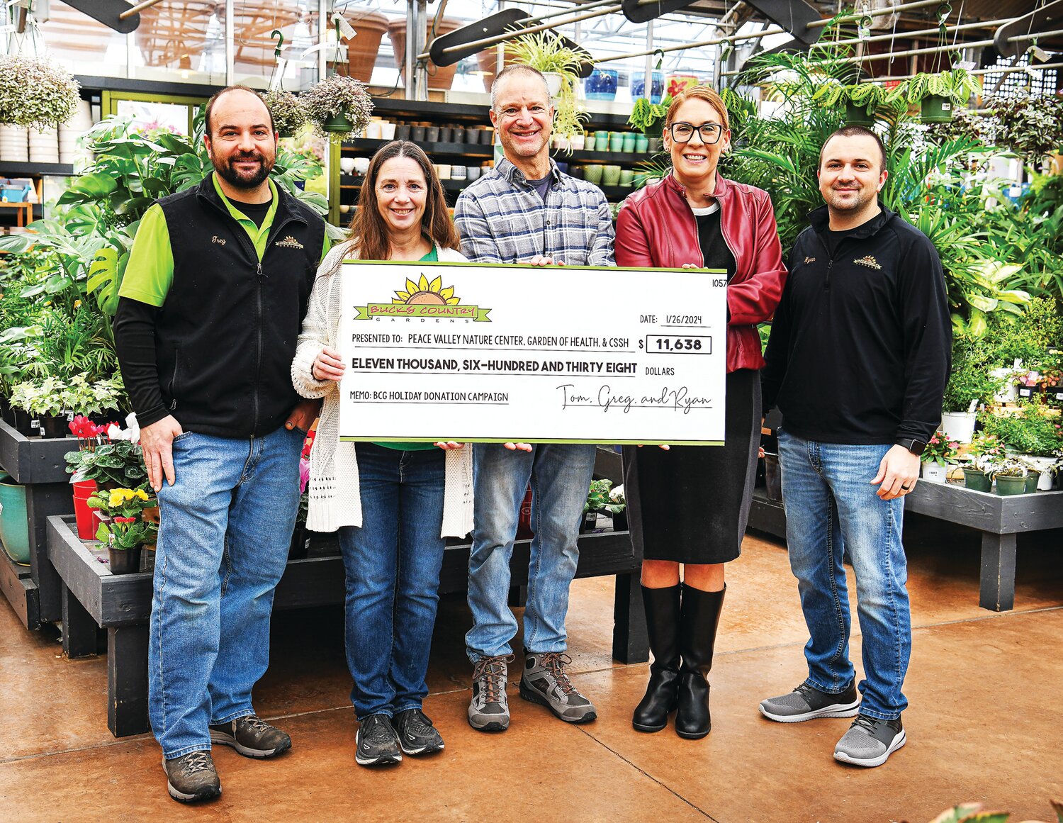 A ceremonial check is presented to Andy Jarin (director, Friends of PVNC), Carol Bauer (founder & COO, Garden of Health Food Bank), and Nicole Buckley-Mormello (executive director, CSSH), by Greg Hebel (landscape division manager) and Ryan Hebel (garden center manager) from Bucks Country Gardens.