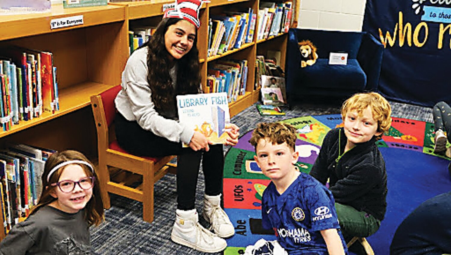 New Hope-Solebury’s Maya Patel reads to Abigail Cunningham, Michael Hoch and Luca Andrews.