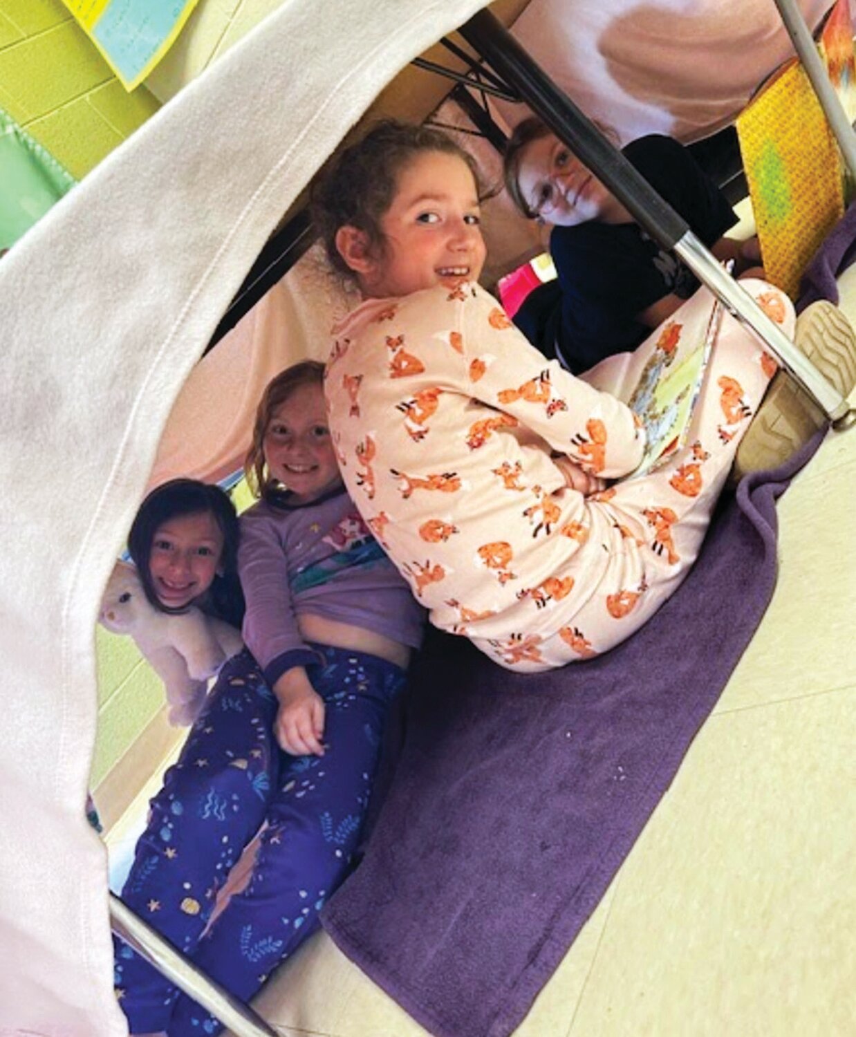 Second grade students in Tricia Fox’s class at Maureen M. Welch Elementary School read books during “Fort Time” on Pajama Day last week.