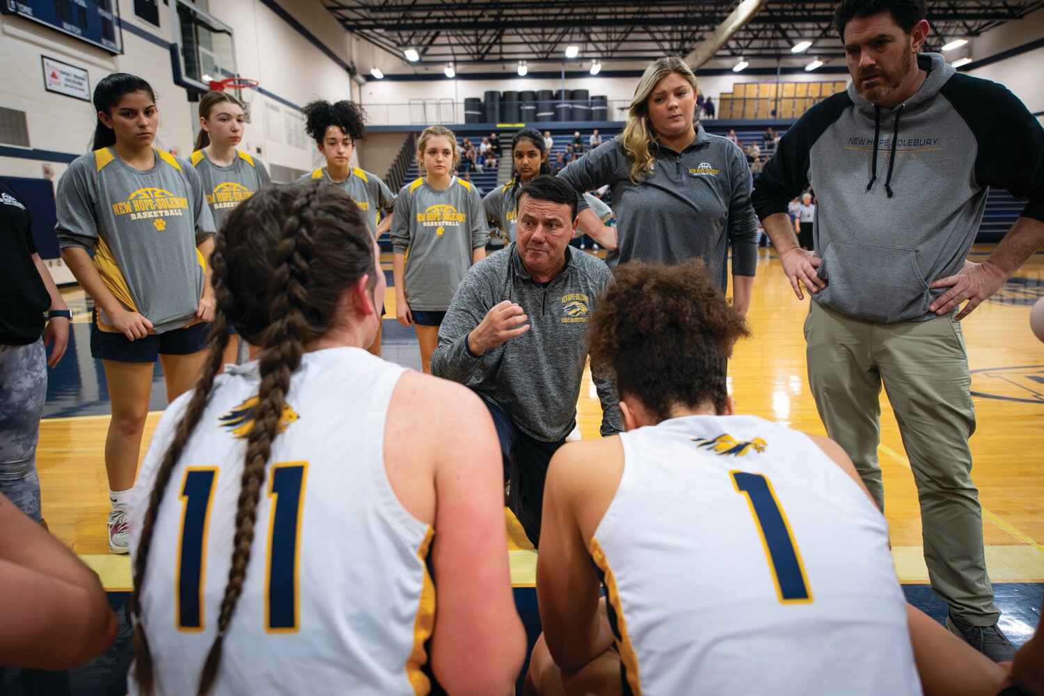 New Hope-Solebury head coach Steve Polinsky stresses defense during a time out early in the first quarter.