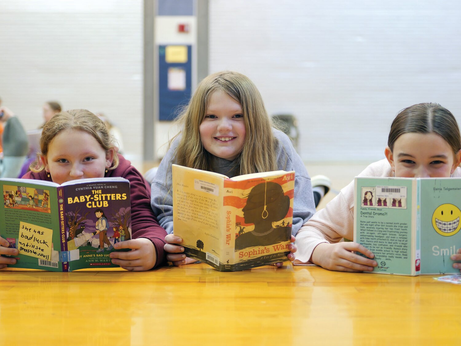 From left: Deibler Elementary School students Elise Lezoche, Hannah Fuhrmann and Sophia Myers read.