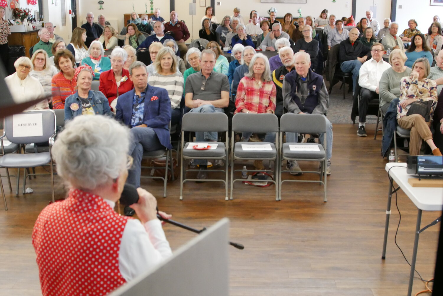 The crowd of 120 gathered at Central Bucks Senior Center in Doylestown listens as Mae Krier speaks.