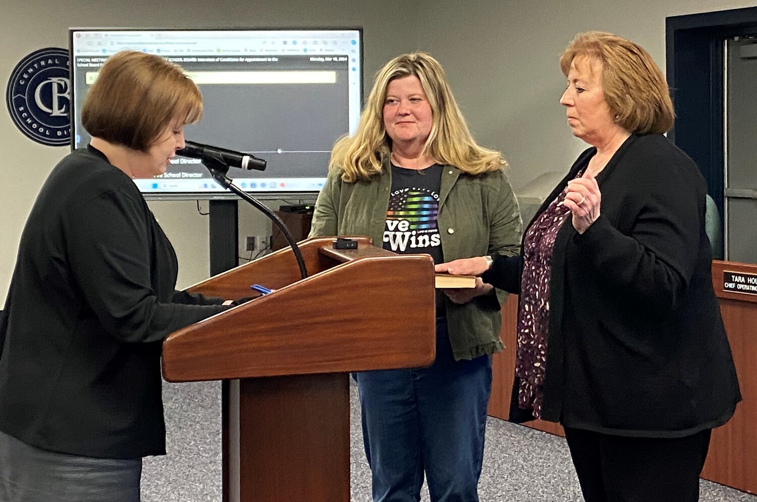 Stephanie Radcliffe, Assistant  to the Superintendent, swears in Jenine Zdanowicz following her appointment to the Central Bucks School Board Monday as Board President Karen Smith looks on.