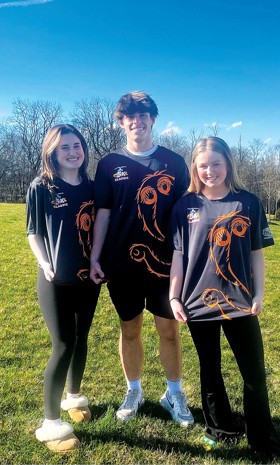 From left: Alexis Mancini, Drew Hendricks and Chelsea Seiler wear the “Mr. Snuffleupagus” T-shirts, which will be distributed to runners for the 2024 Kiwanis-Herald Sesame Place Classic.