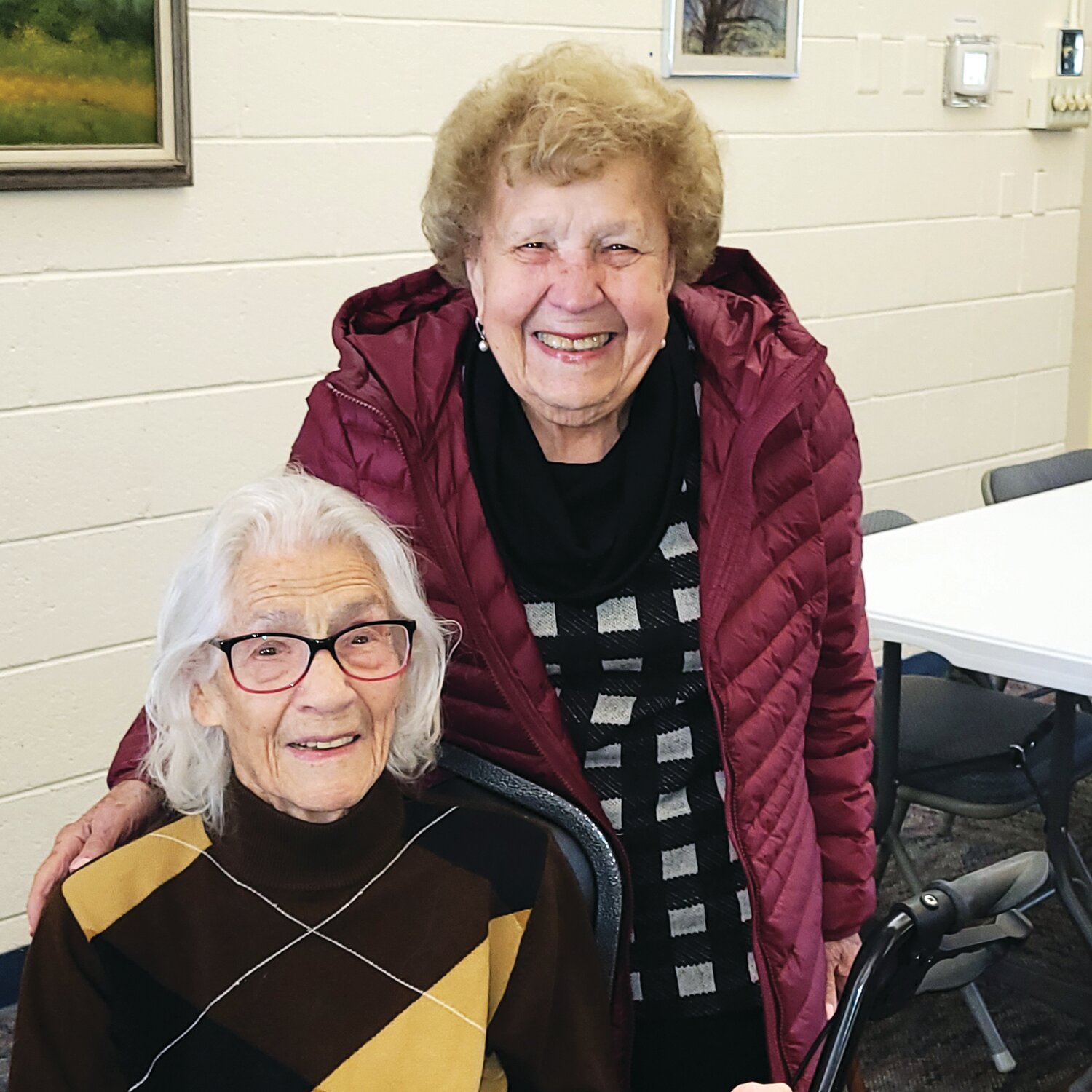 Elizabeth “Liz” Costello, seated, is welcomed into the Centenarian club by 101-year-old Catherine Longabucco following Costello’s  participation in the seated exercise class at the Central Bucks Senior Activity Center.