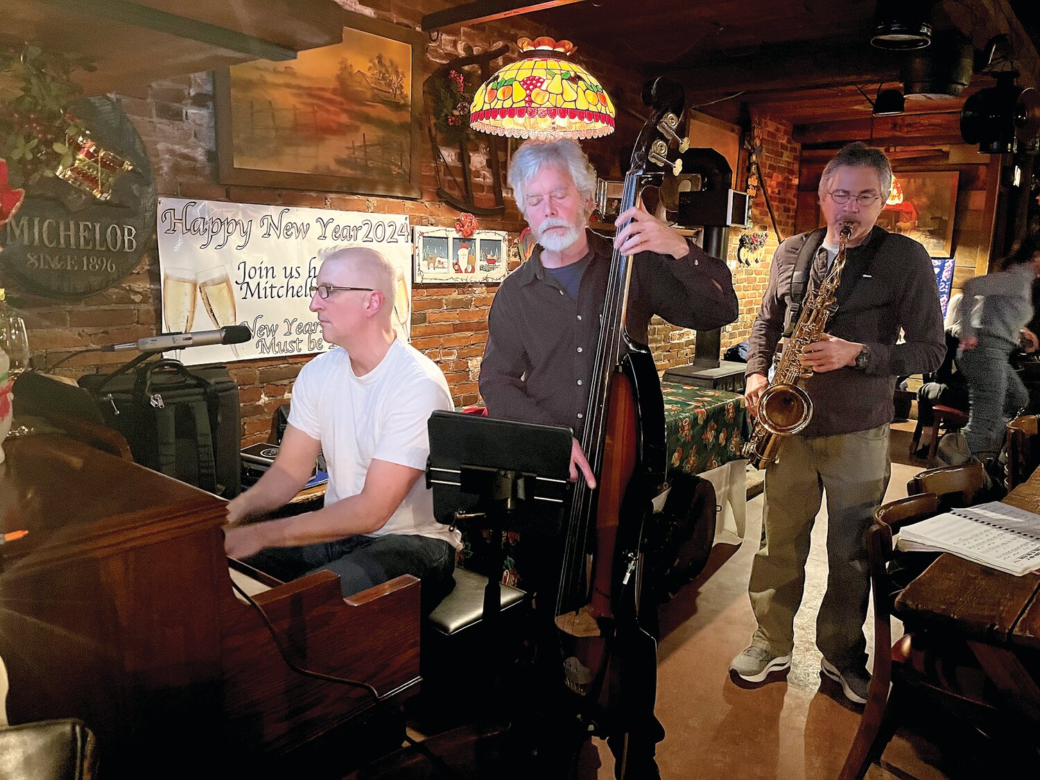 Steve Croce (piano), Dave Paller on bass, and Ron Klein on saxophone collaborate on a number when Lambertville Jazz met at Mitchell’s Cafe in February.