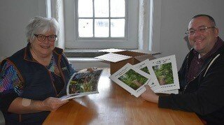 Bucks County Audubon Society Executive Director Michael Celec, right, and volunteer Sally Conyne unbox copies of the new publication, “Honey Hollow Watershed Revisited 2022,” a review of 50 years of life in the Honey Hollow Watershed.