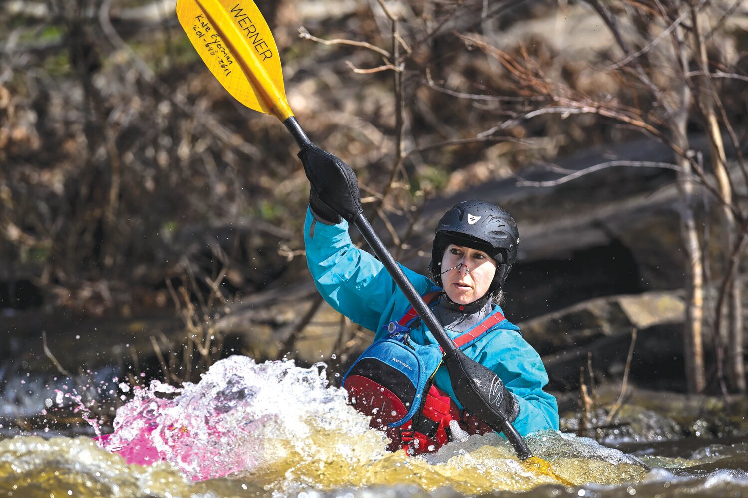 Kate Eyerman drops into some rapids and turns back downstream.
