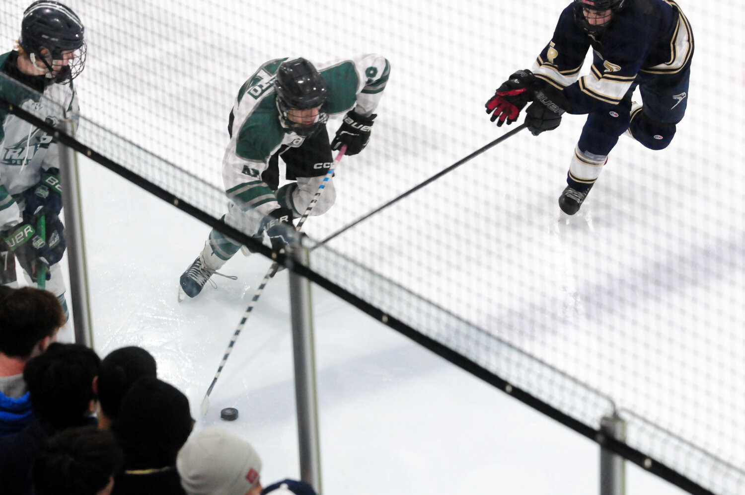 Pennridge senior Tyler Manto, center, is pursued by a Council Rock South defender in the Flyers Cup 2A championship battle won by the Rams March 20 at Hatfield Ice Arena.