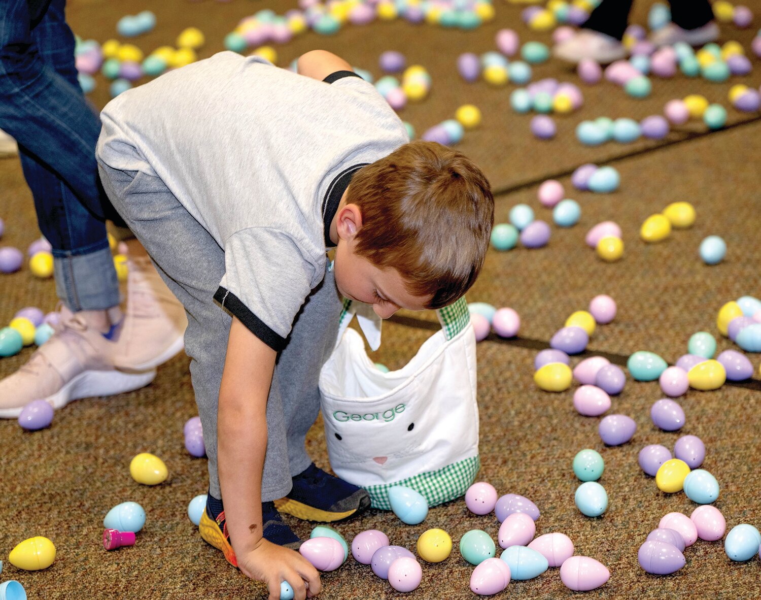 A child picks up eggs.