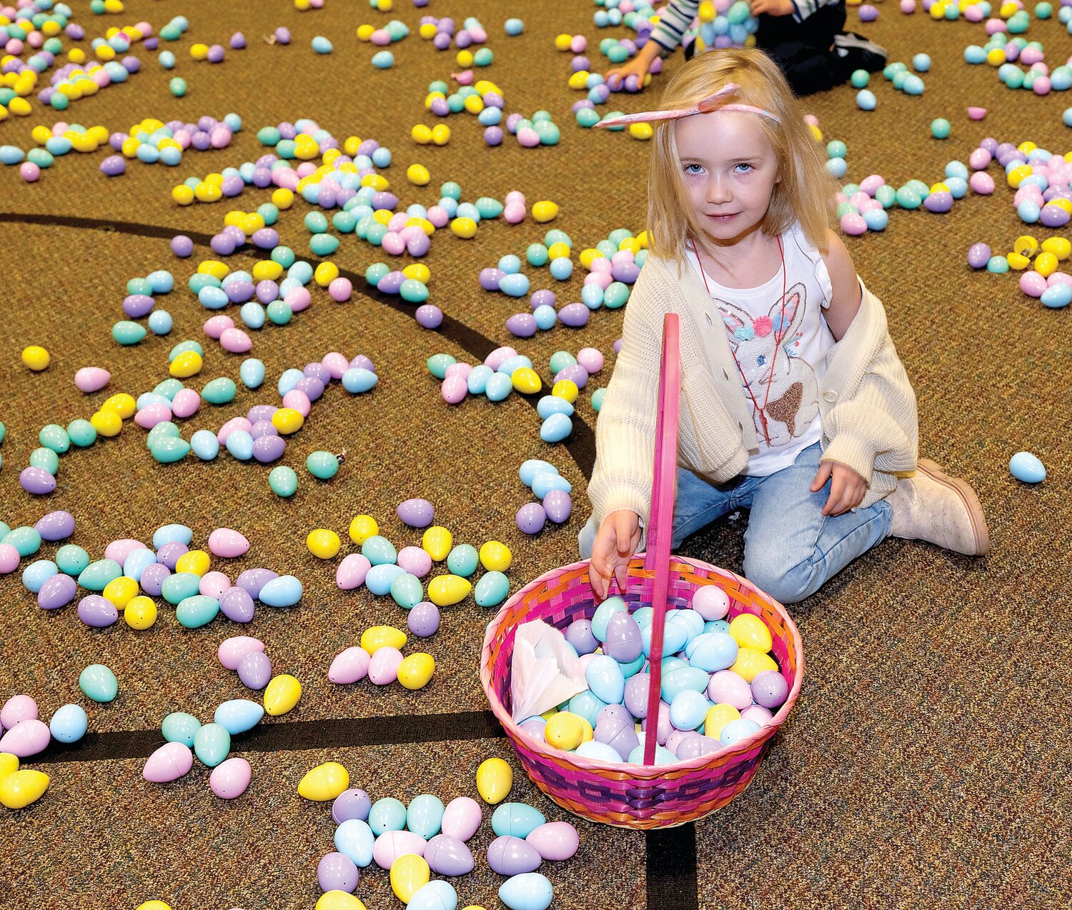 Olivia O’Neill collects eggs.