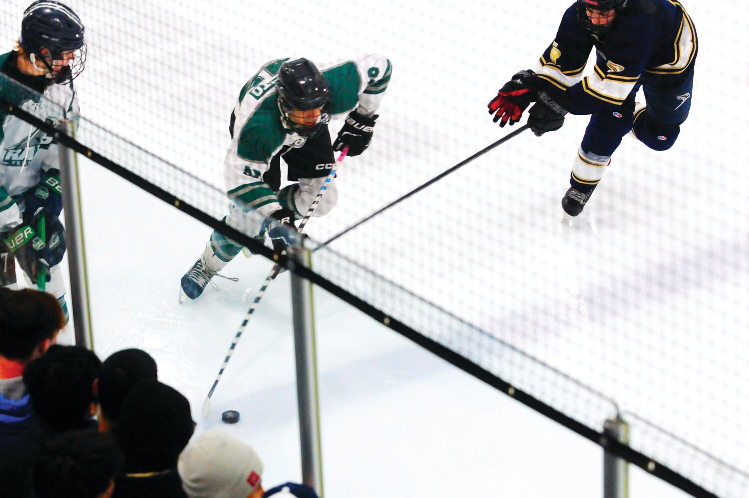 Pennridge senior Tyler Manto, center, is pursued by a Council Rock South defender in the Flyers Cup 2A championship battle won by the Rams March 20 at Hatfield Ice Arena.