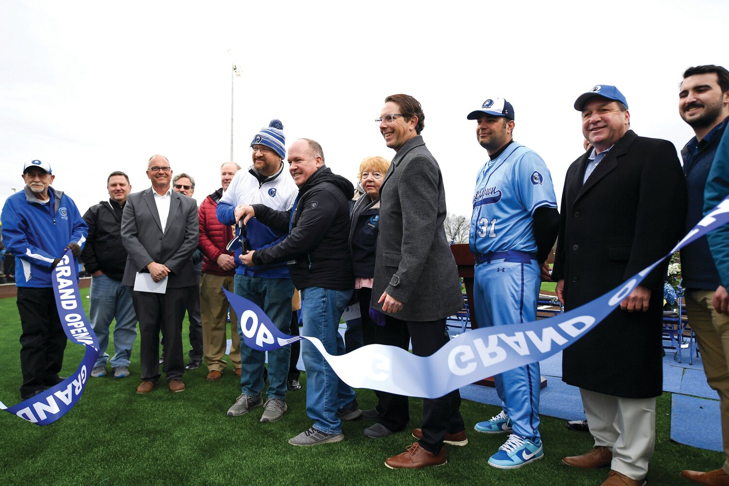 Members of the Quakertown Community School District cut the ribbon during the grand opening ceremony for the district’s new multi-purpose field. In the center are Todd Hippauf, Quakertown Community School District Board president (hat); board member Glenn Iosue and Dr Matt Friedman, superintendent.