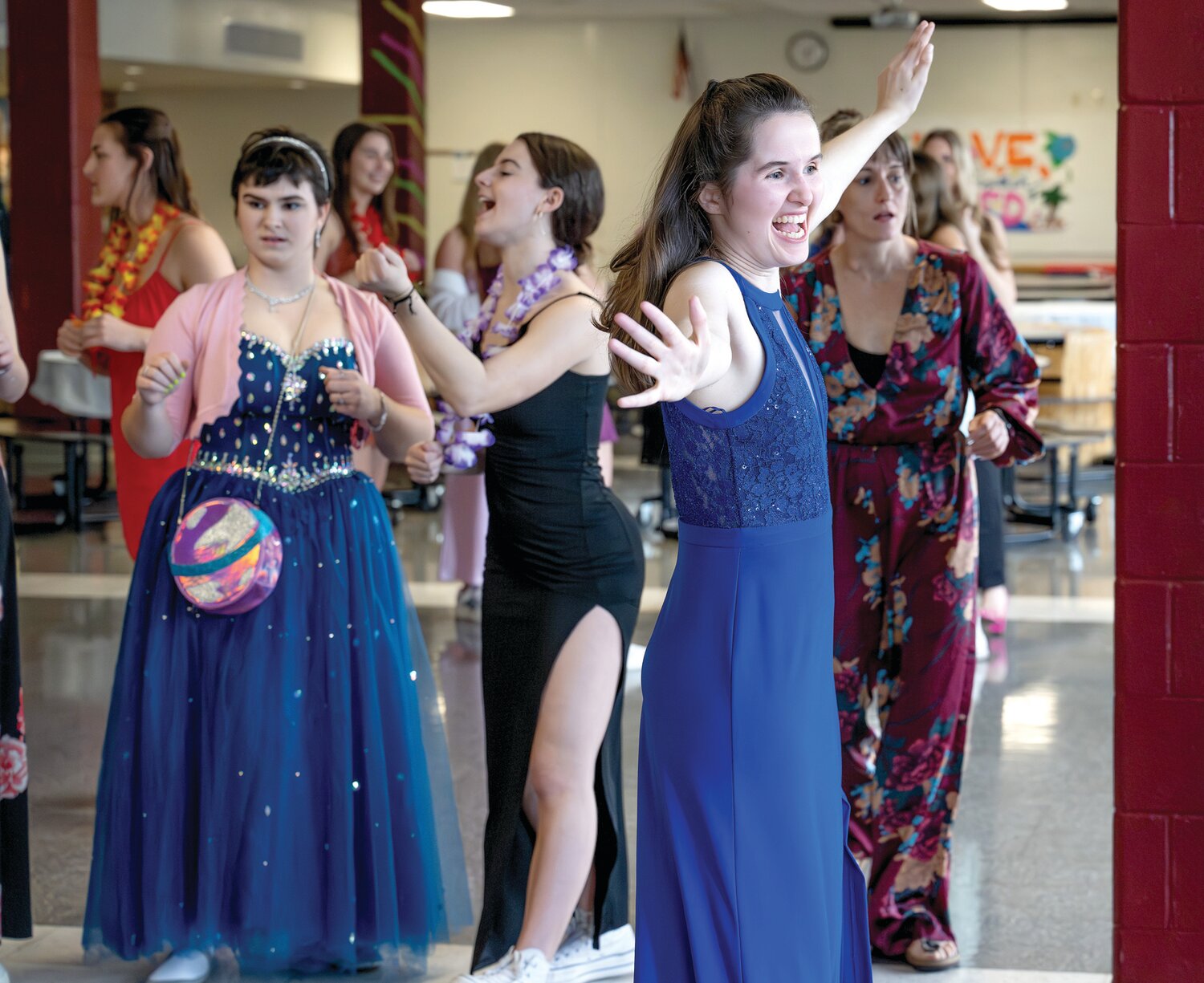 Evi McCormack, Calli Pasternack and Rachel Southard gather with friends to dance during Central Bucks East High School’s first Unified Prom.