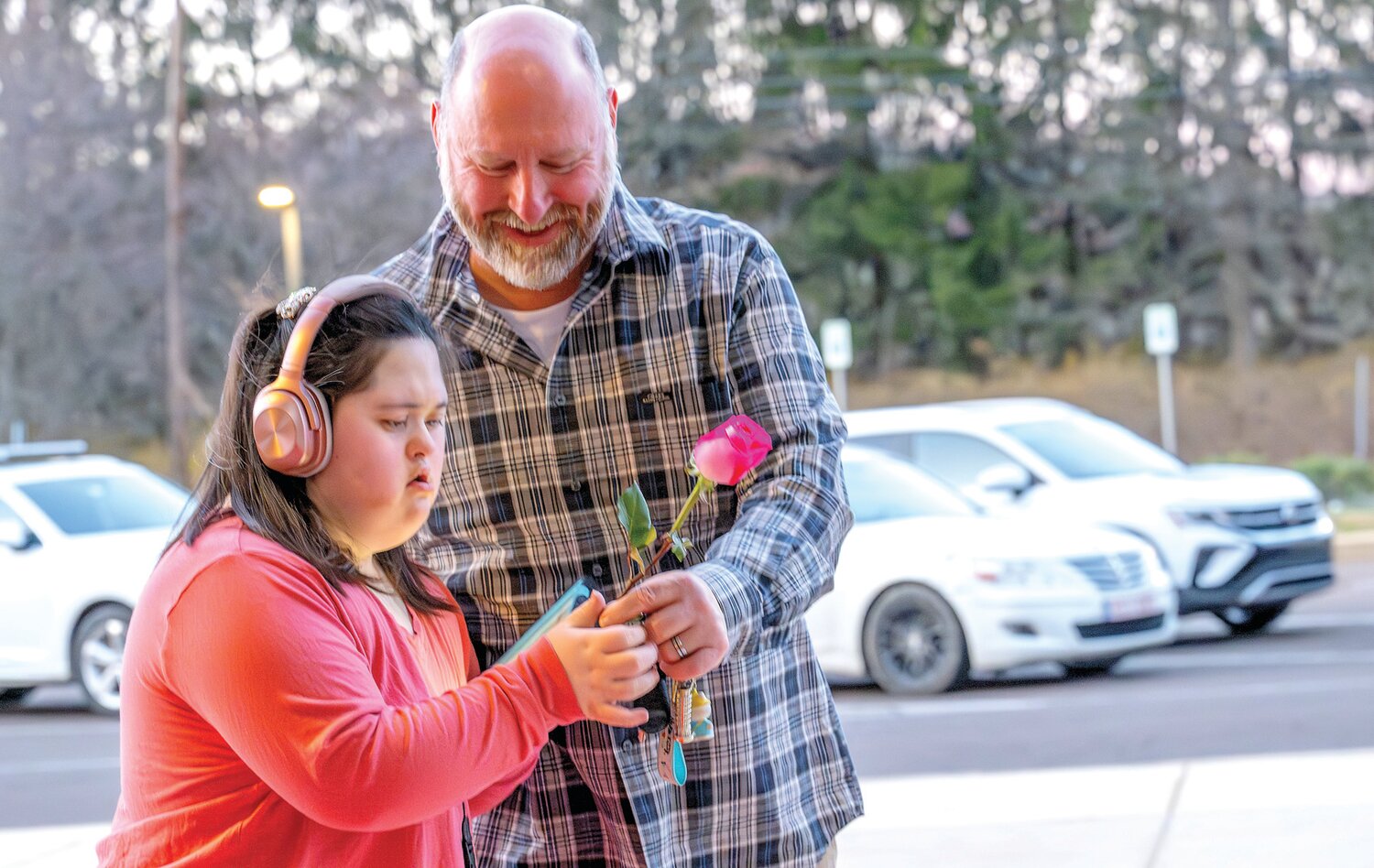 Gabby Christy gets a rose from her father on her way out of Central Bucks East High School’s first Unified Prom March 15.