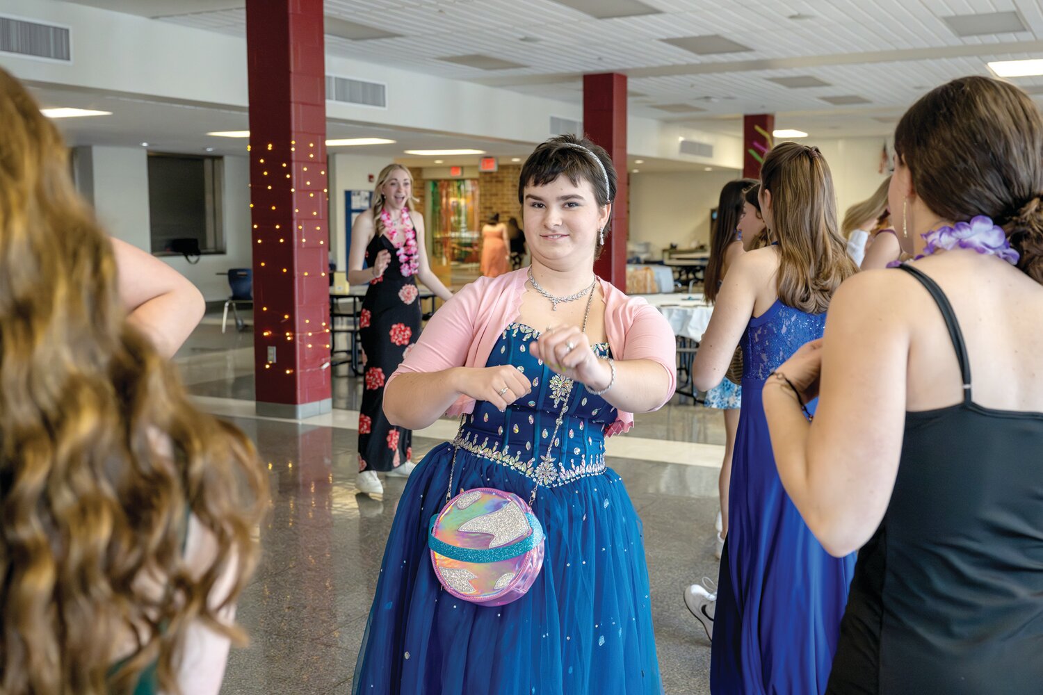 Evi McCormack, Calli Pasternack and Rachel Southard gather with friends to dance during Central Bucks East High School’s first Unified Prom March 15.