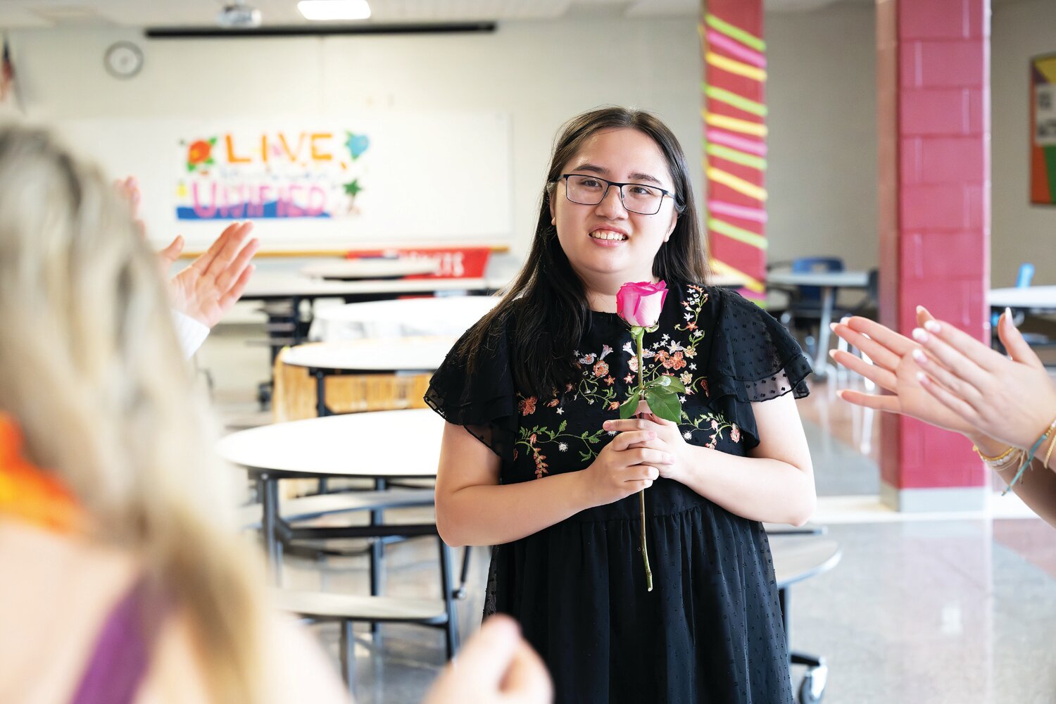 Clutching a big rose, Ellie Nguyen enjoys dancing with friends during Central Bucks East’s first Unified Prom March 15.