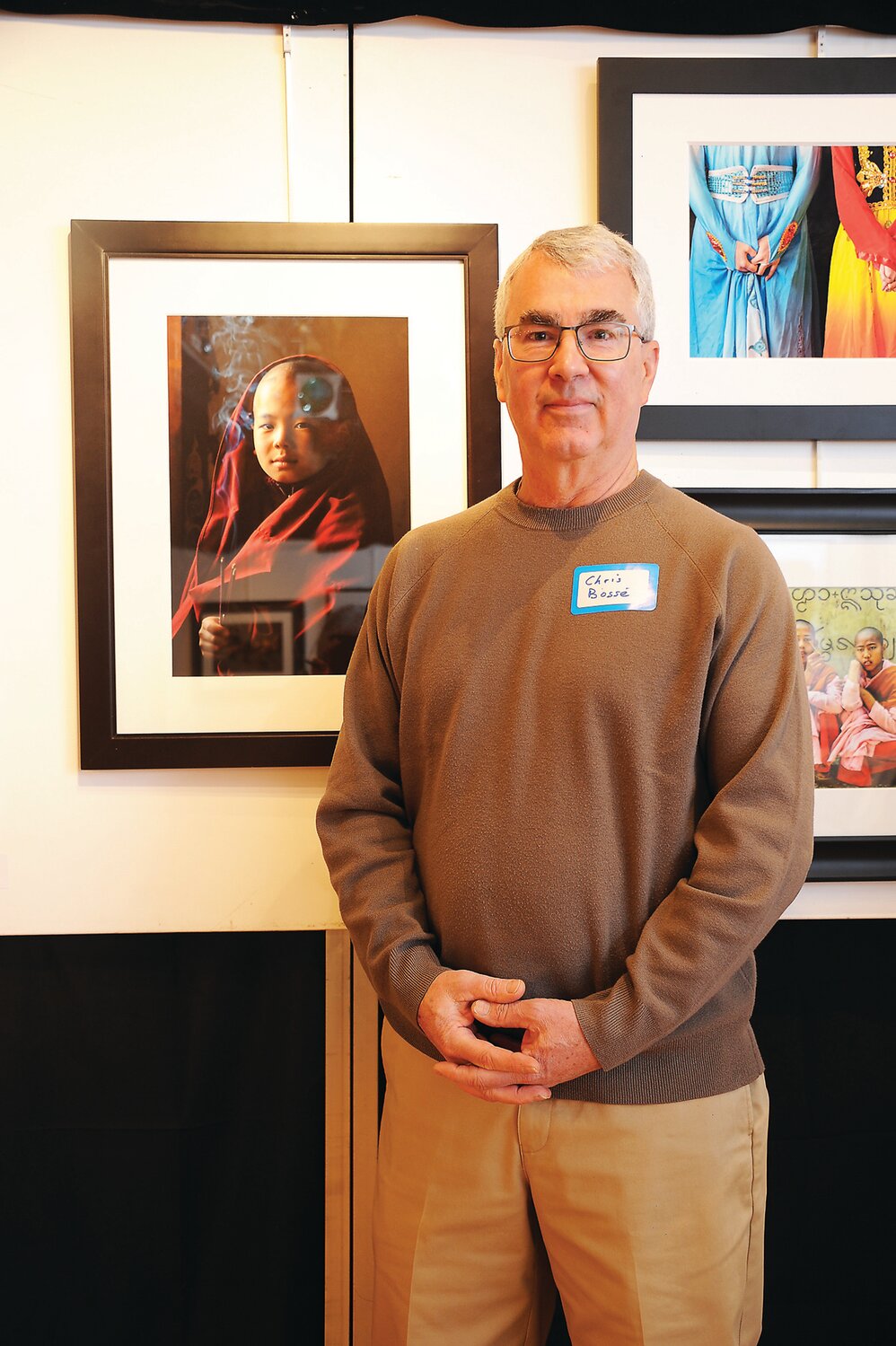 Christopher Bosse standing next to his work “Contemplation,” which won the prize for Portraiture.