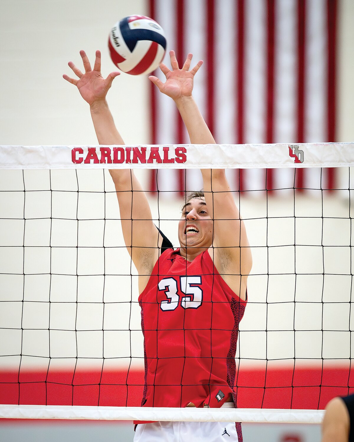Central Bucks East’s Reid Miller with the block attempt in the second game.
