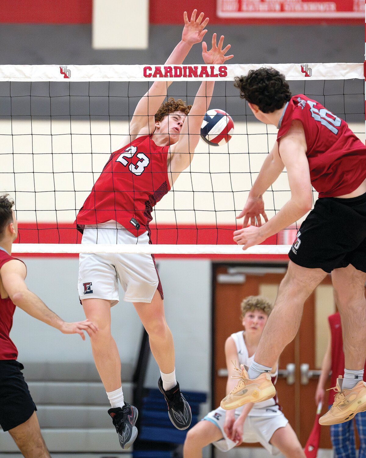 Central Bucks East’s Evan Blank twists to attempt a block on the spike from Upper Dublin’s Seanus Frayne.