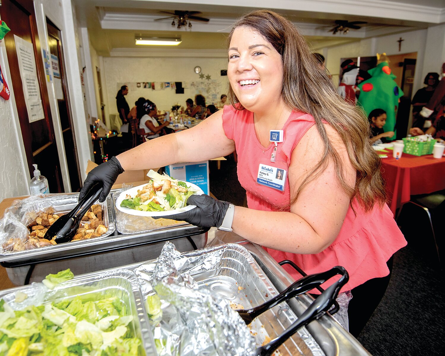 Kelsey Gaspar, St. Luke’s Community Health Initiatives coordinator, serves a meal during the summer meals program in Allentown.