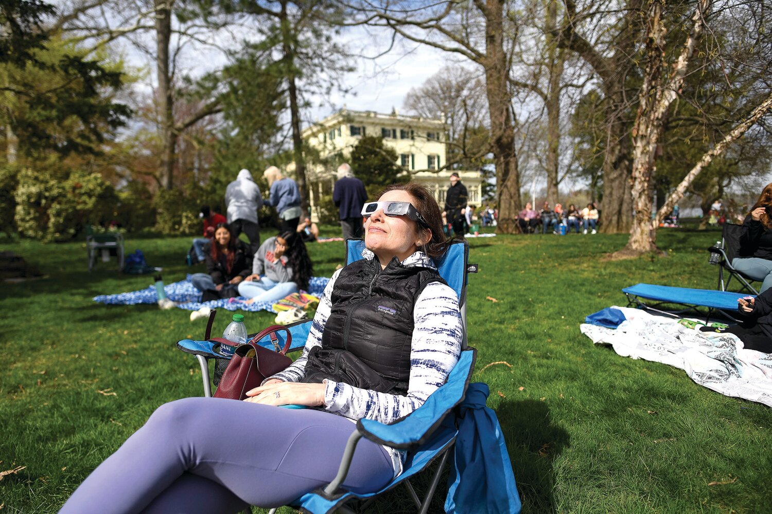 Cecilia Richardson, of Annapolis. Md., enjoys the eclipse through a brief peak in the clouds.