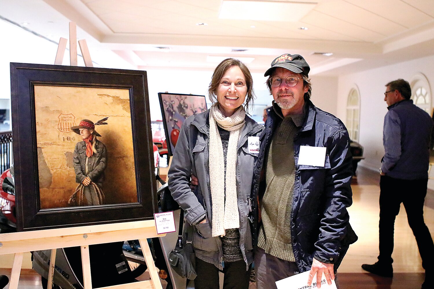Artist Robert Papp, right, with his wife, Lisa, and his painting, “Elsa,” at a prior event.