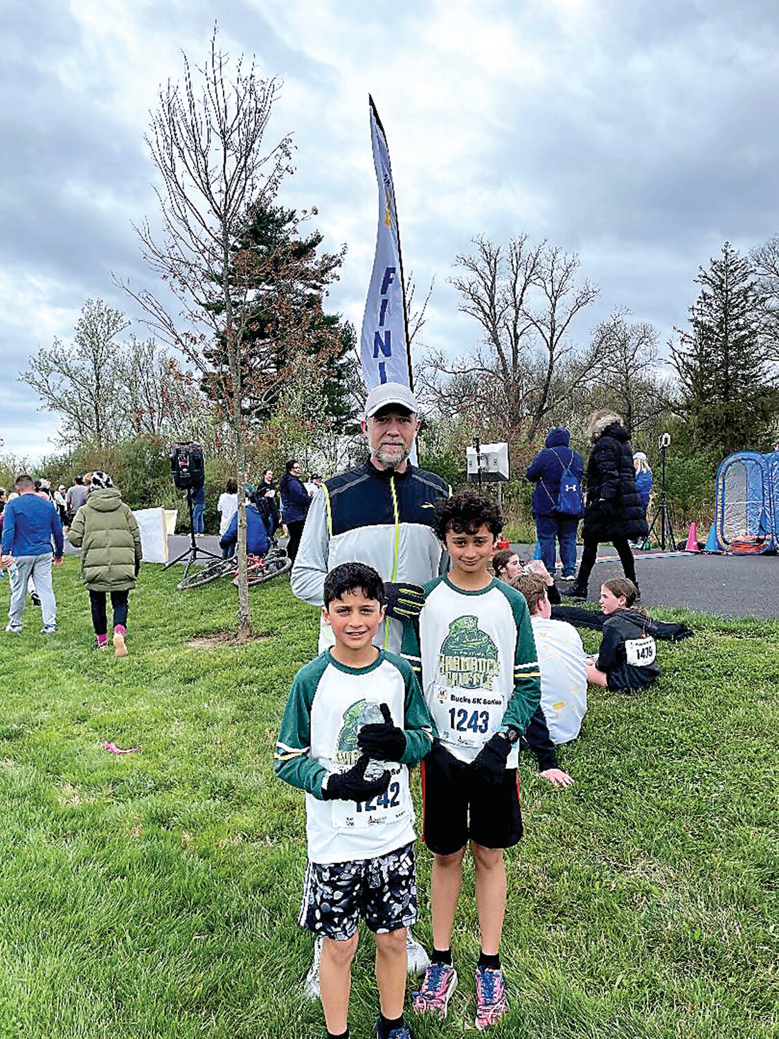 Stan Brownell stands with his two boys, Alric, left, and Avery, right, after Saturday’s Be Kind 5K at Holicong Park in Buckingham Township.