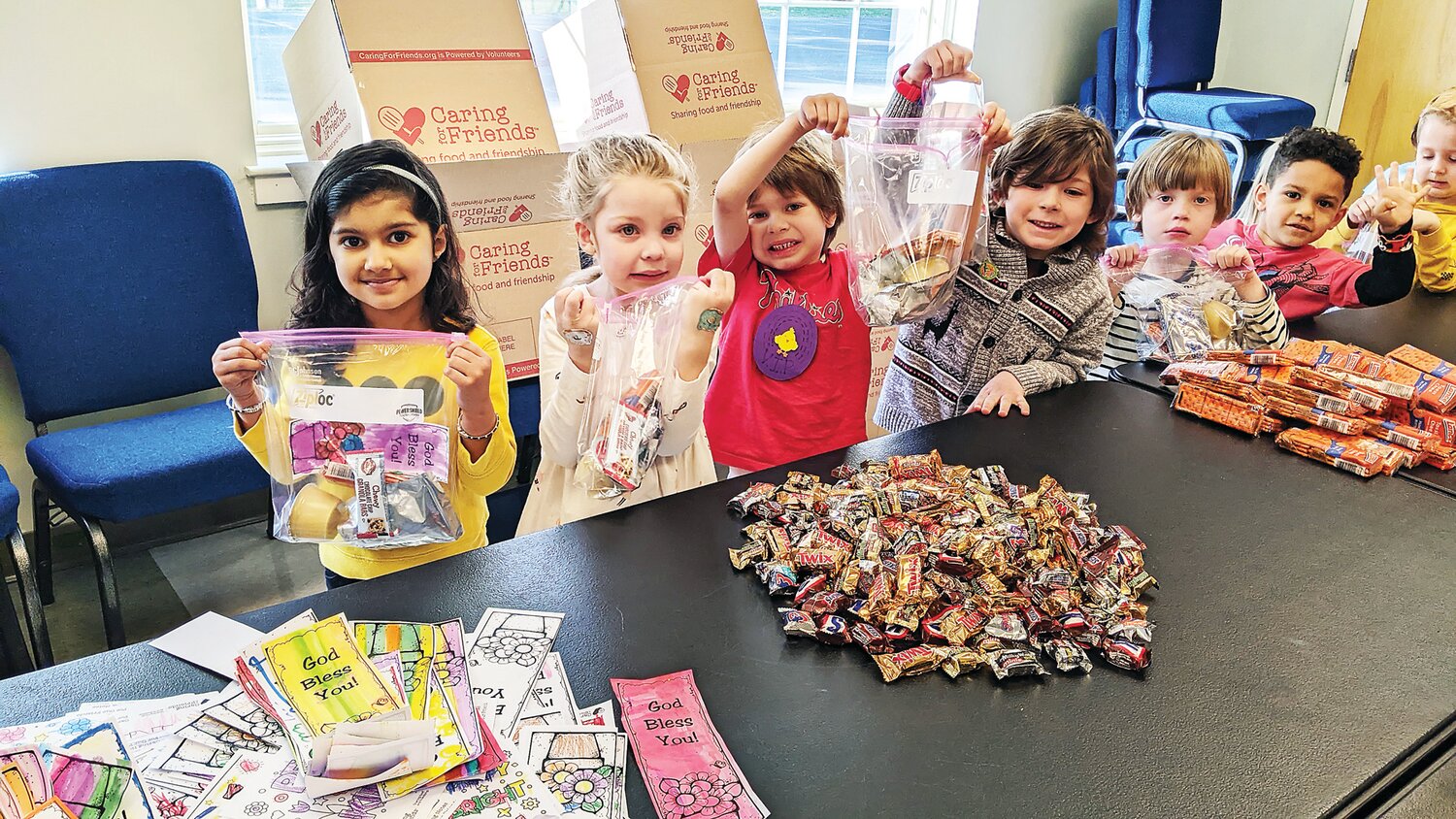 Woodside Christian Preschool students pack snack bags for Caring for Friends.