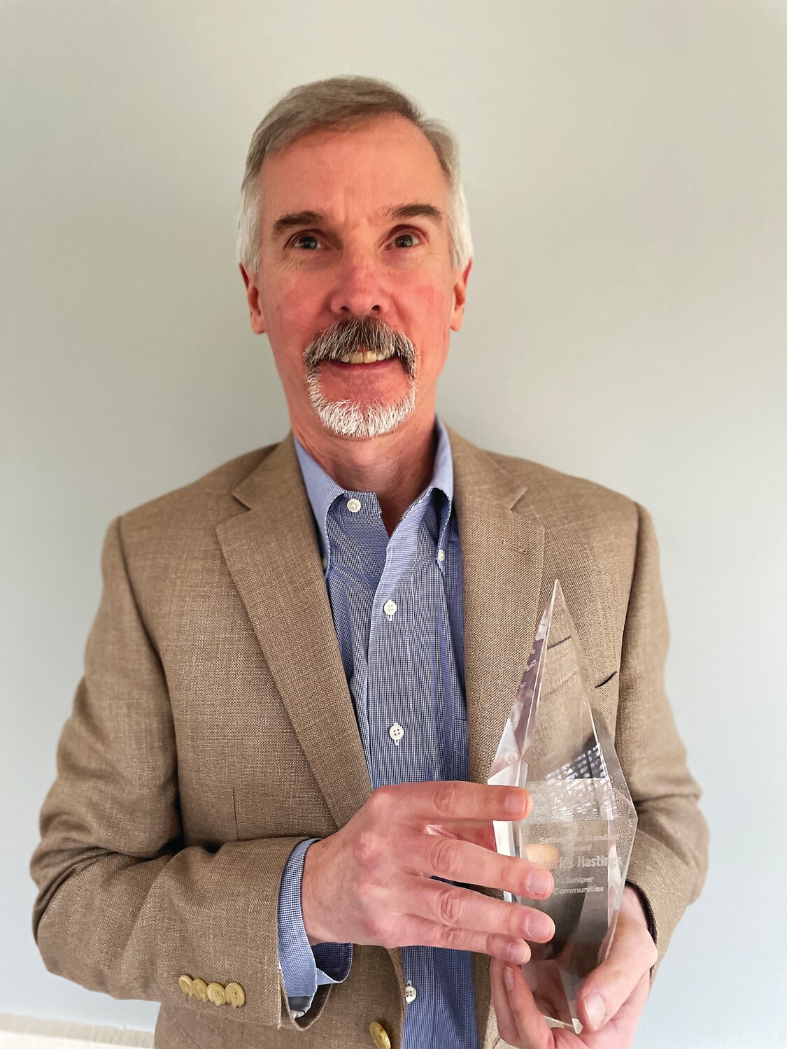 Chuck Hastings holds his McKnight’s Pinnacle Award.